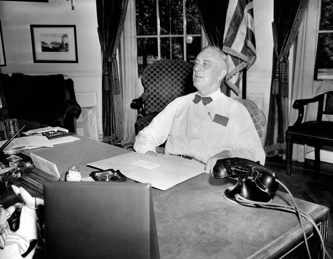 U.S. President Franklin D. Roosevelt wears an expression of confidence and determination as he receives visitors in his White House office, 1944.