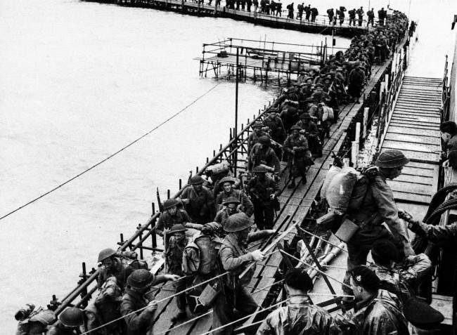 British reinforcement troops from the Royal Pioneers Corps and Royal Engineers embark LCI at an English port, 1944.