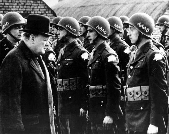 British Prime Minister Winston Churchill reviews American troops at a base in England on the eve of D-Day, 1944.