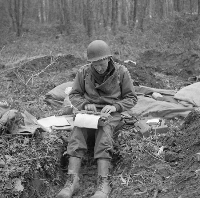 Don Whitehead, Associated Press correspondent, writes his story of the landing at Anzio Beach in Italy, from a fox hole. 1944