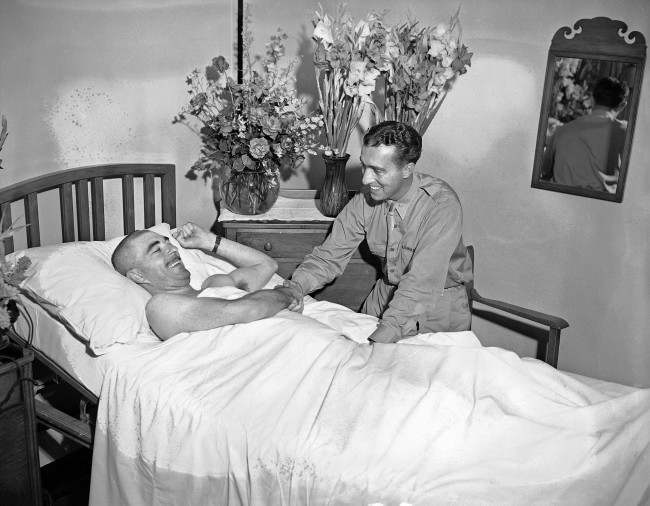 George Tucker, Associated Press war correspondent thanking Capt. James J. Ryan, of Philadelphia and chief of the Neurological Div. of the U.S.A. base hospital at Cairo on a two week leave. 1943