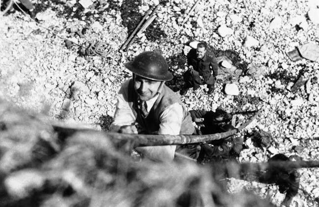 J. Wes Gallagher, Associated Press war correspondent in London, takes lessons in the Tommy-gun with the Canadian Army’s Commando School. 1942