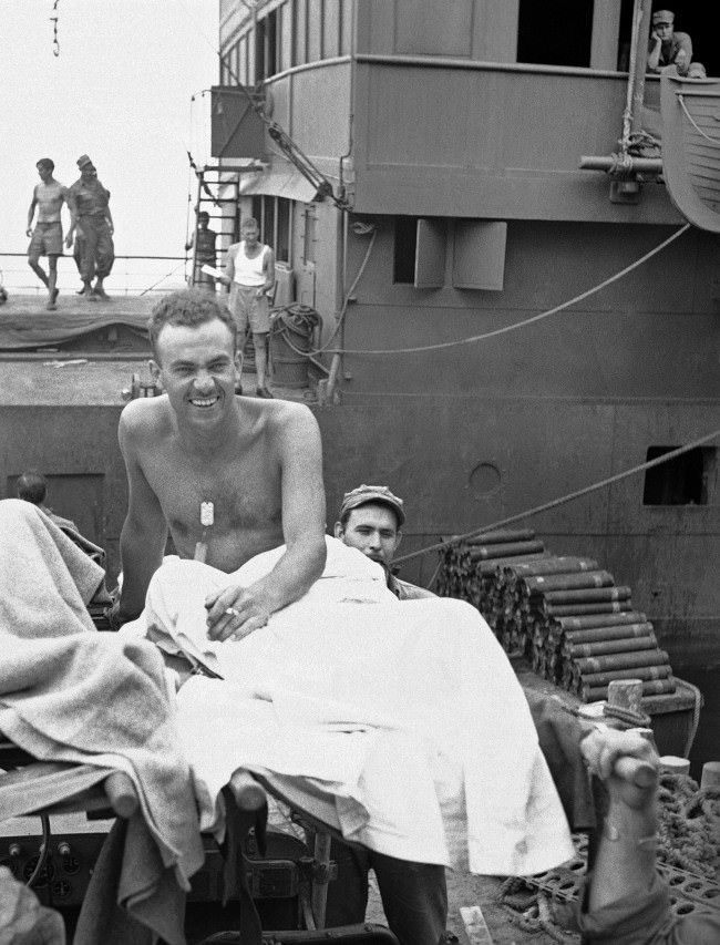 William F. Boni of New York, Associated Press War Correspondent, heads for treatment of mine shell splinter wounds. 1943