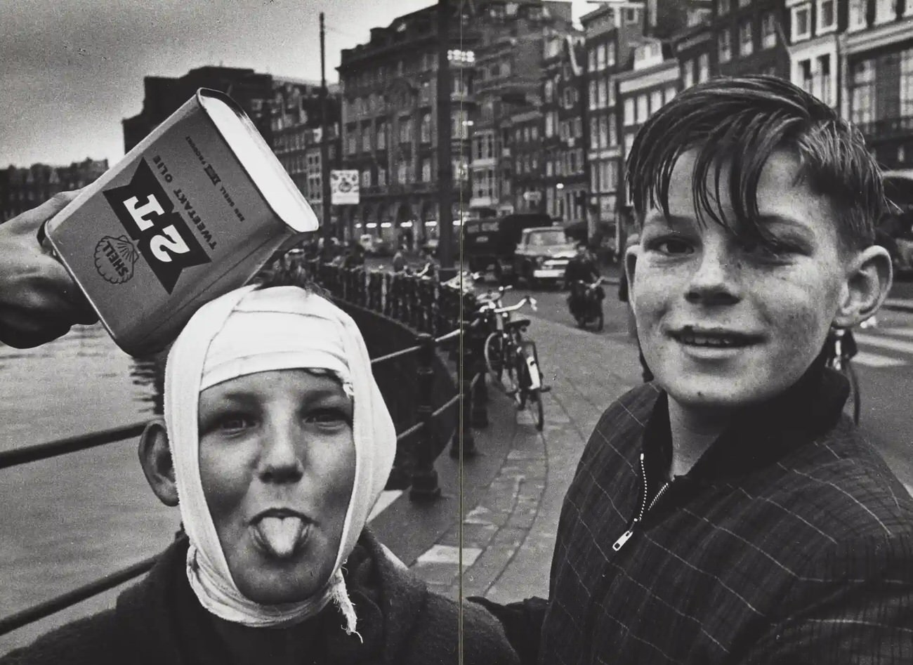 Two boys pose on the street, Rokin, near the Langebrugsteeg, Amsterdam, 1950-1960