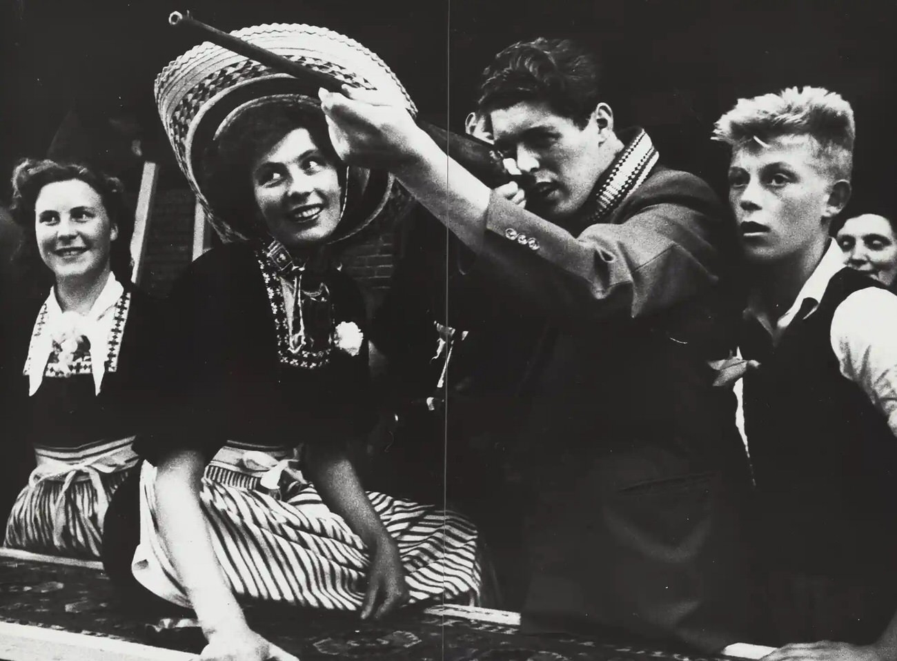 Young people at a shooting gallery at the fair in Volendam circa 1955–1956