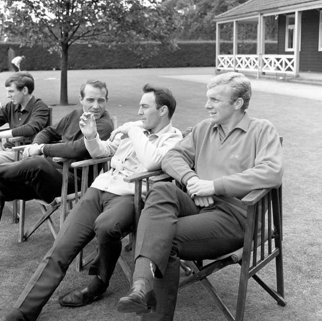 Jimmy Greaves holds the attention of fellow England World Cup squad players Bobby Moore (right) and Ron Springett as they relax at Roehampton, London, 1966.