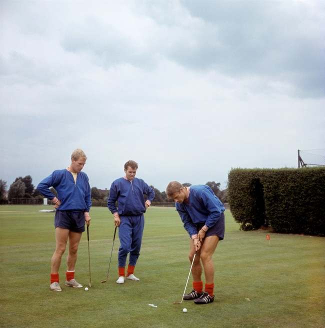 England’s Roger Hunt putts watched by Ron Flowers and John Connelly (C) at Roehampton, 1966.