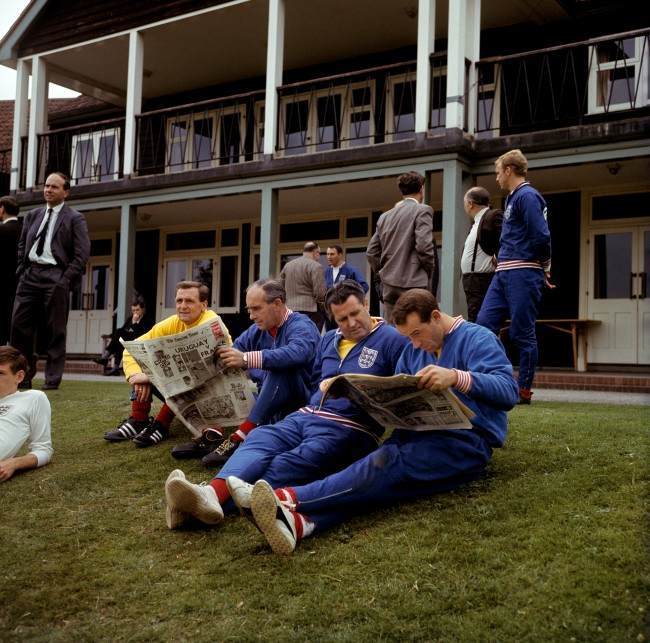 England trainer Les Cocker, manager Alf Ramsey, physio Harold Shepherdson and Jimmy Greaves read the morning newspapers during a relaxing training session at Roehampton, 1966.