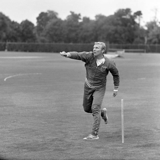 England captain Bobby Moore turns his arm over as the players relax with a game of cricket, 1966.