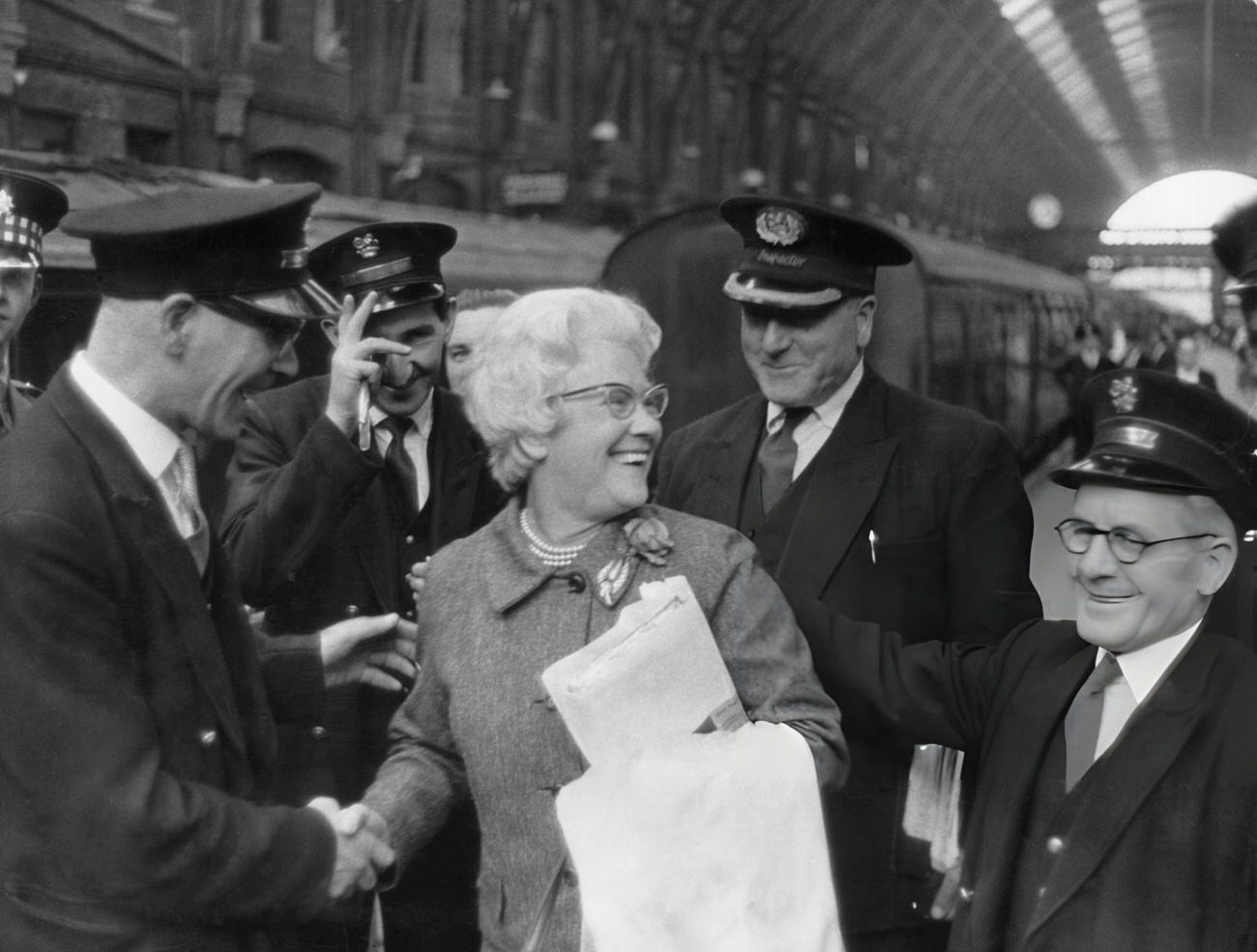 Cissie Charlton is greeted by station staff at King's Cross, London, 1966.