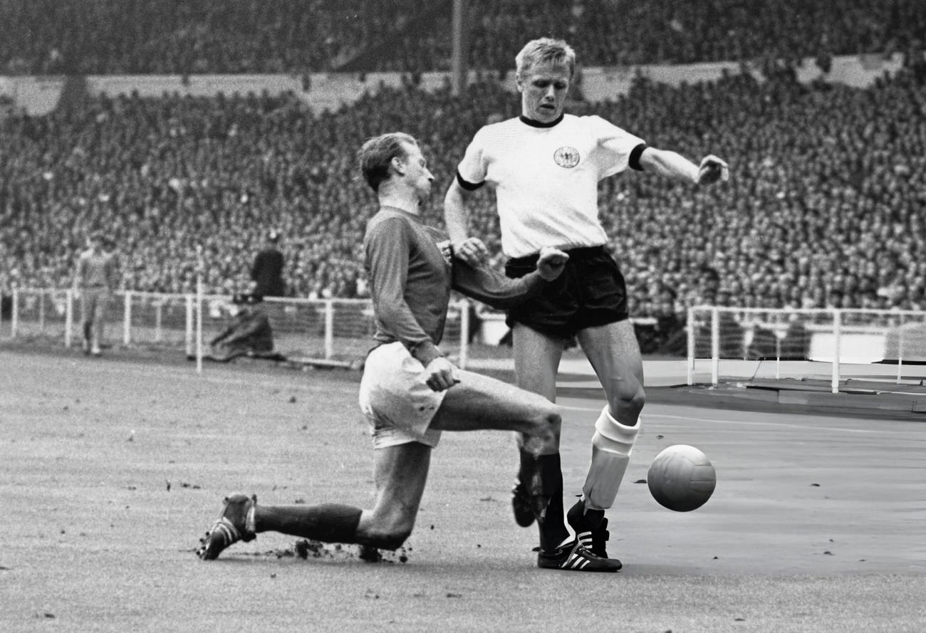 England's Jackie Charlton tackling West Germany's Held, during the World Cup Final, 1966.