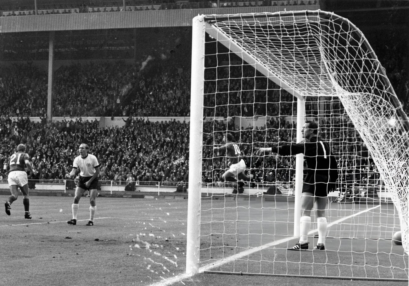 Geoff Hurst of England jumps for joy after scoring England's first goal during their World Cup Final match, 1966.