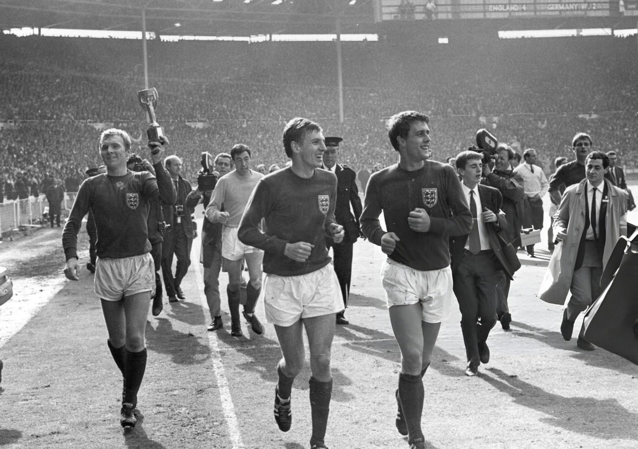 England captain Bobby Moore and colleague Geoff Hurst lead the team around the pitch, 1966.