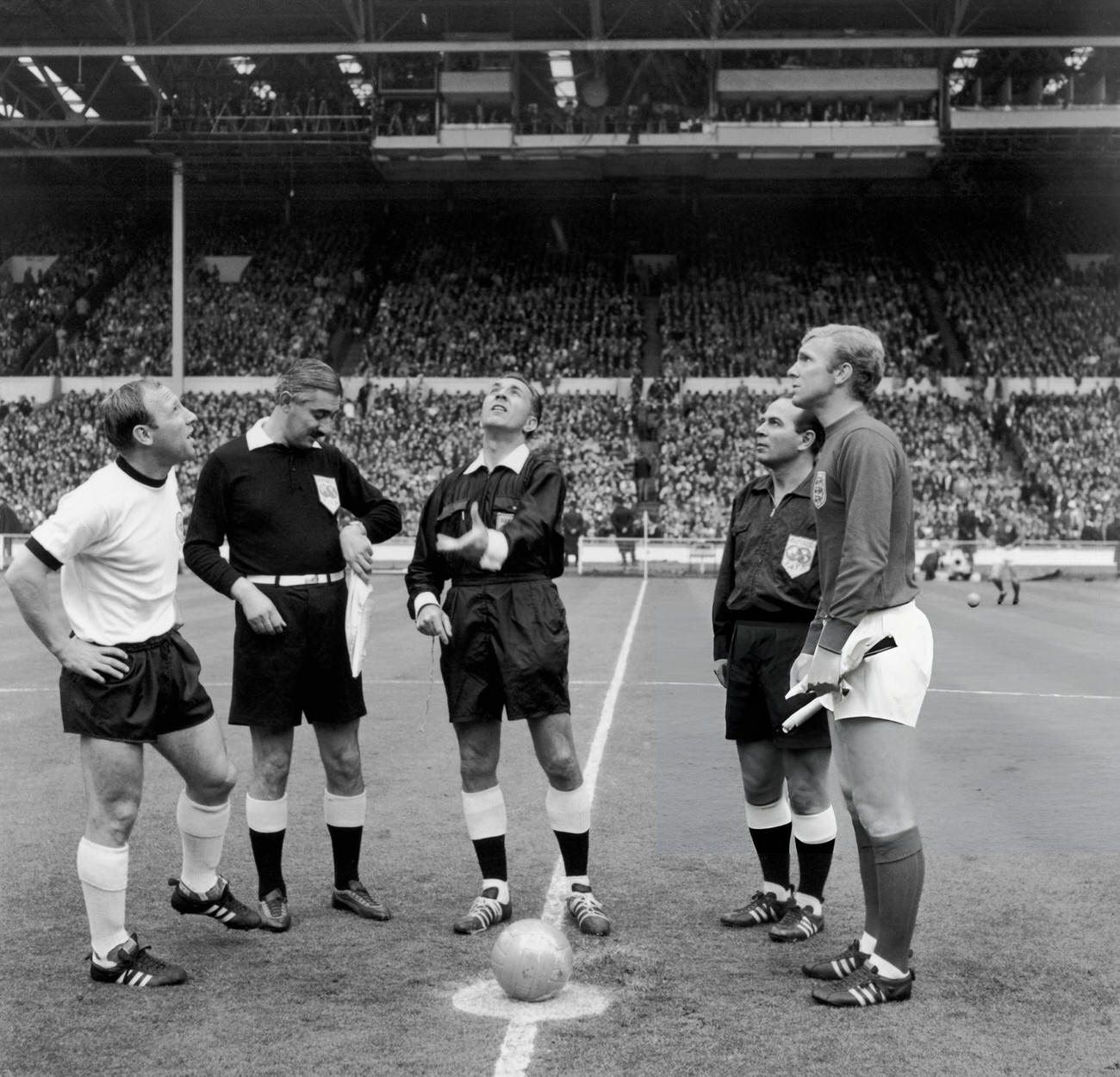 Referee Gottfried Dienst tosses the coin before the start of the World Cup final, 1966.