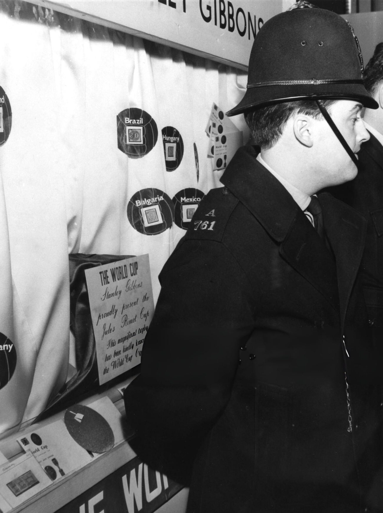 A policeman stands in front of the display case from which the Jules Rimet trophy was stolen, 1966.