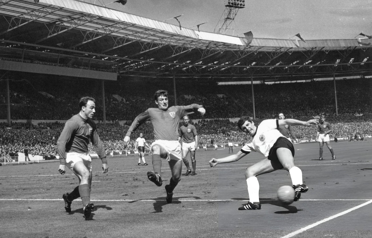 George Cohen and Martin Peters in action for England during the World Cup Final match, 1966.