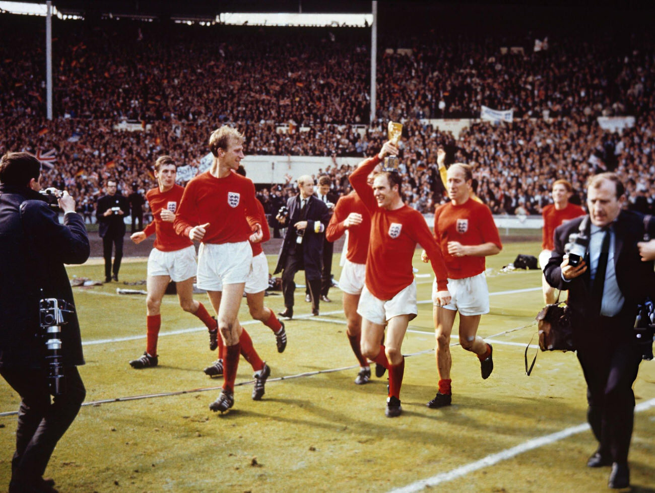 The England team raise the Jules Rimet trophy in the air following their 4-2 victory, 1966.