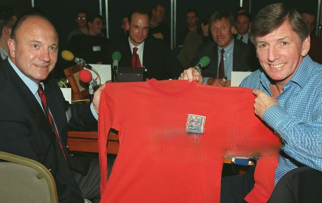 England's Martin Peters and George Cohen are reunited with Roger Hunt's red England No.21 International jersey, 1966.