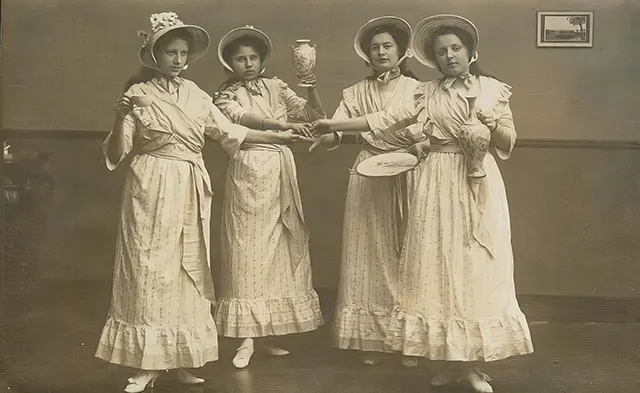 Young women hold fancy china ready for their tea party.