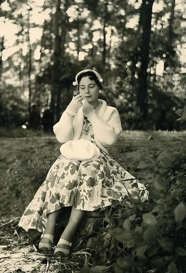 A young woman checks her makeup.