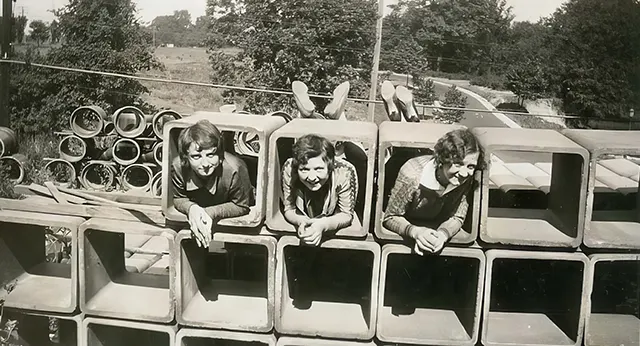 Young girls have fun at a construction site.