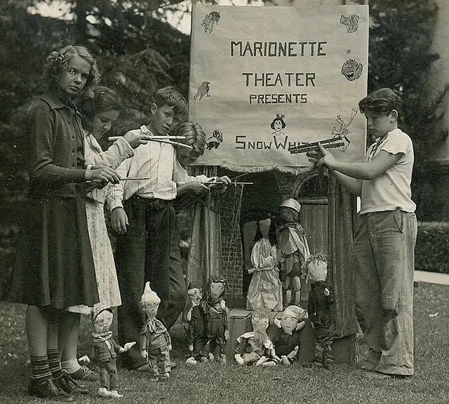 Children playing with puppets.