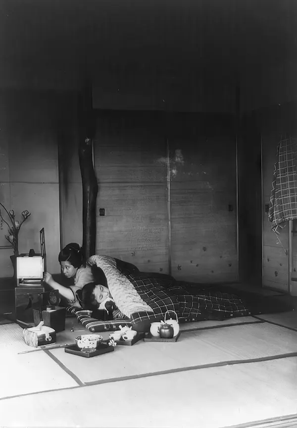 Japanese bedroom with thick quilt used as a bed, 1890-1923.