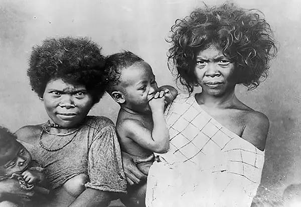 Indigenous Filipinos hold baby, 1890-1923.