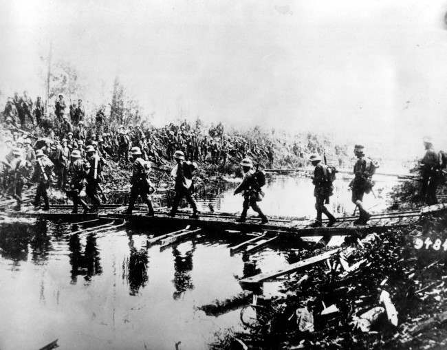 German troops pass over a temporary bridge at the western front.