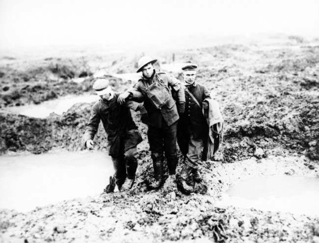 Canadian and German wounded help one another through the mud during the capture of Passchendaele in Belgium sometime between July and November 1917.