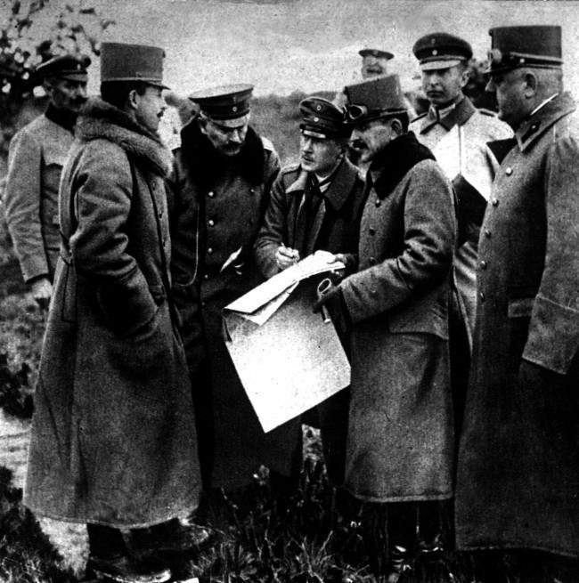 The German Kaiser (3rd left) and the Emperor of Austria (2nd left) studying a map of Northern Italy during a visit to the Italian Front, 1918