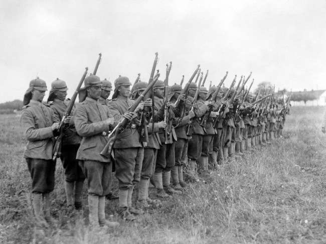 German soldiers wearing their new helmets, which have been modified to remove the spike.