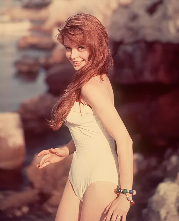 A flirtatious Brigitte Bardot in a white swimsuit, 1950s.