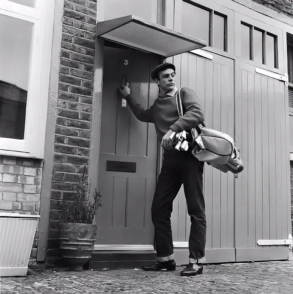 Sean Connery leaves his basement flat in London for a game of golf, 1962.