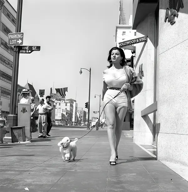 Actress Joan Bradshaw keeps heads turning as she walks down Hollywood Boulevard, 1957.