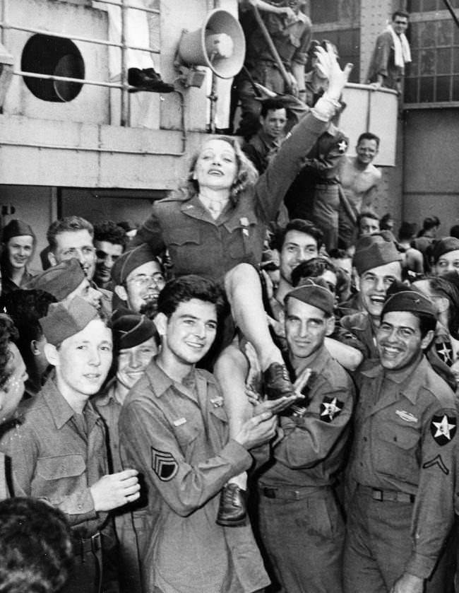 Movie actress Marlene Dietrich greets veterans on the Monticello after the ship docked in New York City on July 20, 1945 in World War II.