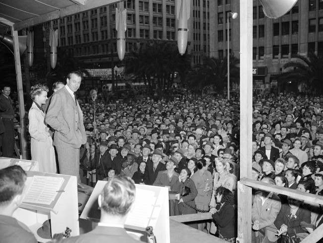 Volunteer salesman Gary Cooper takes time out from work in a new movie to chalk up the highest record for selling Defense Bonds at the Defense House in Pershing Square in Los Angeles, California on Feb. 8, 1942, after making a stirring 15-minute speech, the longest of his public career.