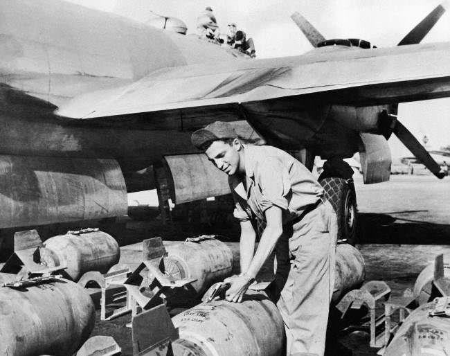 Sgt. John Greenstreet, the son of film actor, Sydney Greenstreet, handling bombs at the 20th Bomber Command in India on Feb. 6, 1945, where he is armament inspector.