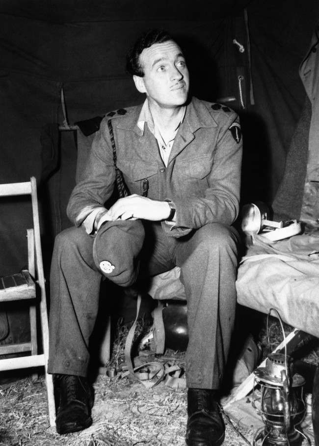 Lieutenant Colonel David Niven, British film star, now with SHAEF, seen in his tent somewhere in Normandy, France on July 5, 1944.