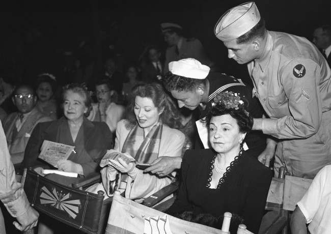 Service men keep Greer Garson, film star, pushing the autograph pencil at Orson WellesÂ big music show in Hollywood, Los Angeles, free to men in uniform, on August 9, 1943.