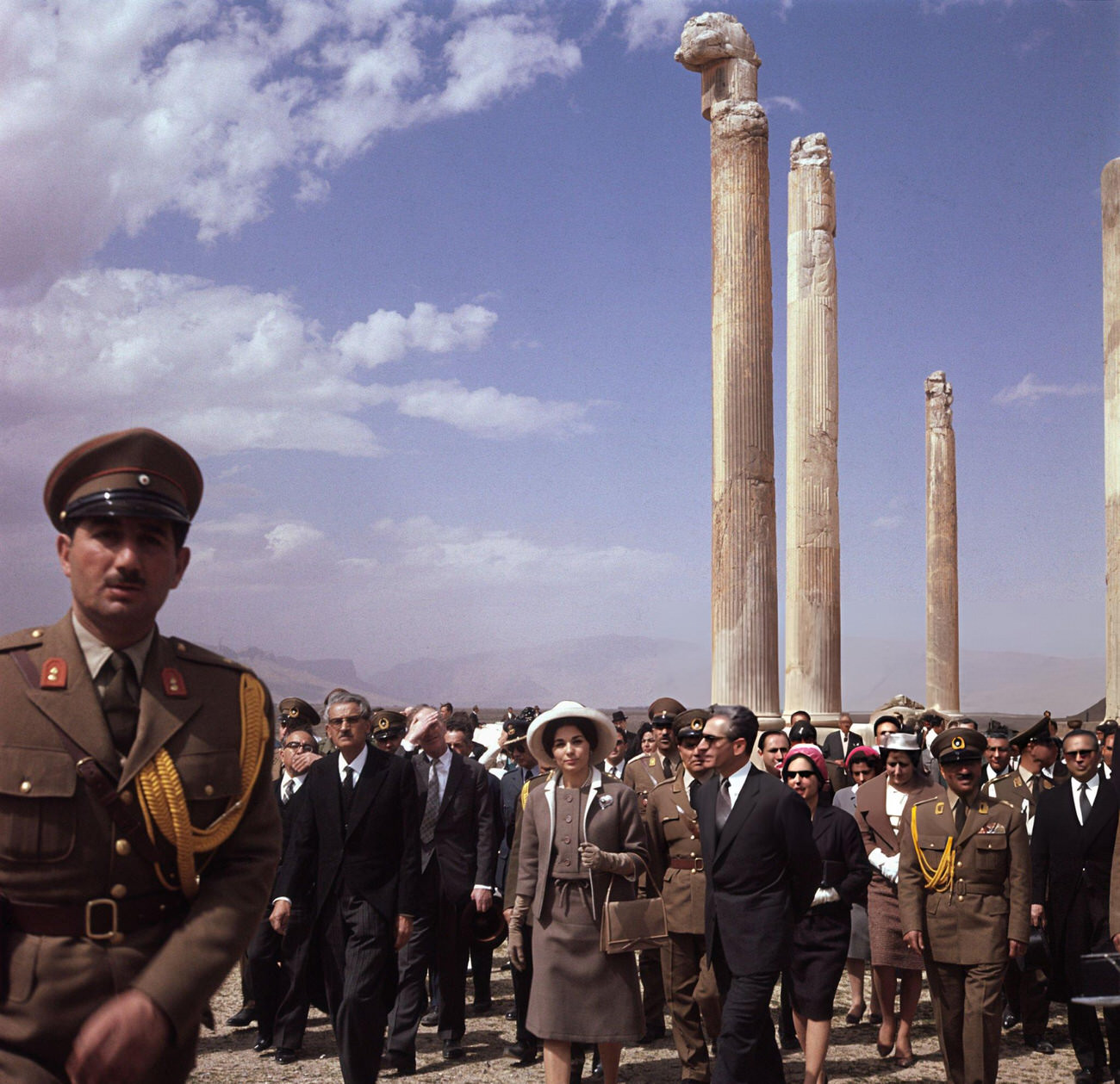 The Shah of Iran and his third wife, Queen Farah, accompanied by officials, on a visit to Persepolis, the ancient capital of Persia, 1960s.