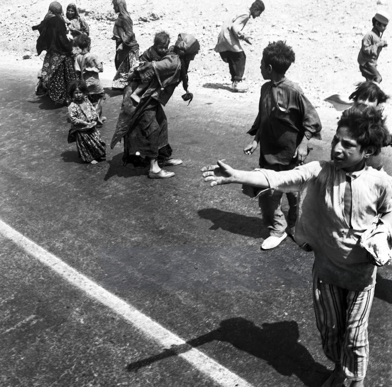 Children begging along a road in Iran, 1960s.