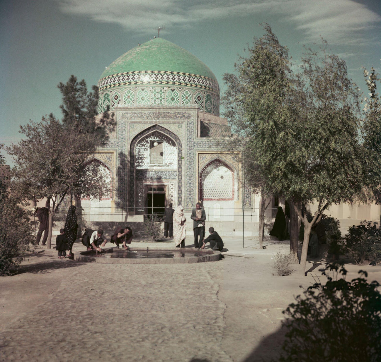 Visitors washing their hands and faces in a pool in front of a shrine near Mashhad, the capital of Razavi Khorasan Province in Iran, circa 1960.