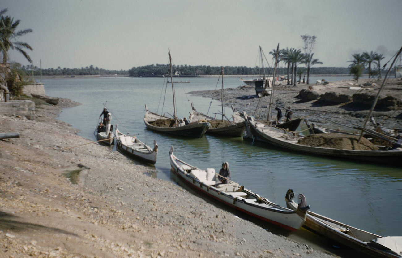 Sailboats and rowing boats moored on a tributary of the Shatt al-Arab river near Khorramshahr, just north of the city of Abadan in Khuzestan Province of southwest Iran, circa 1960.