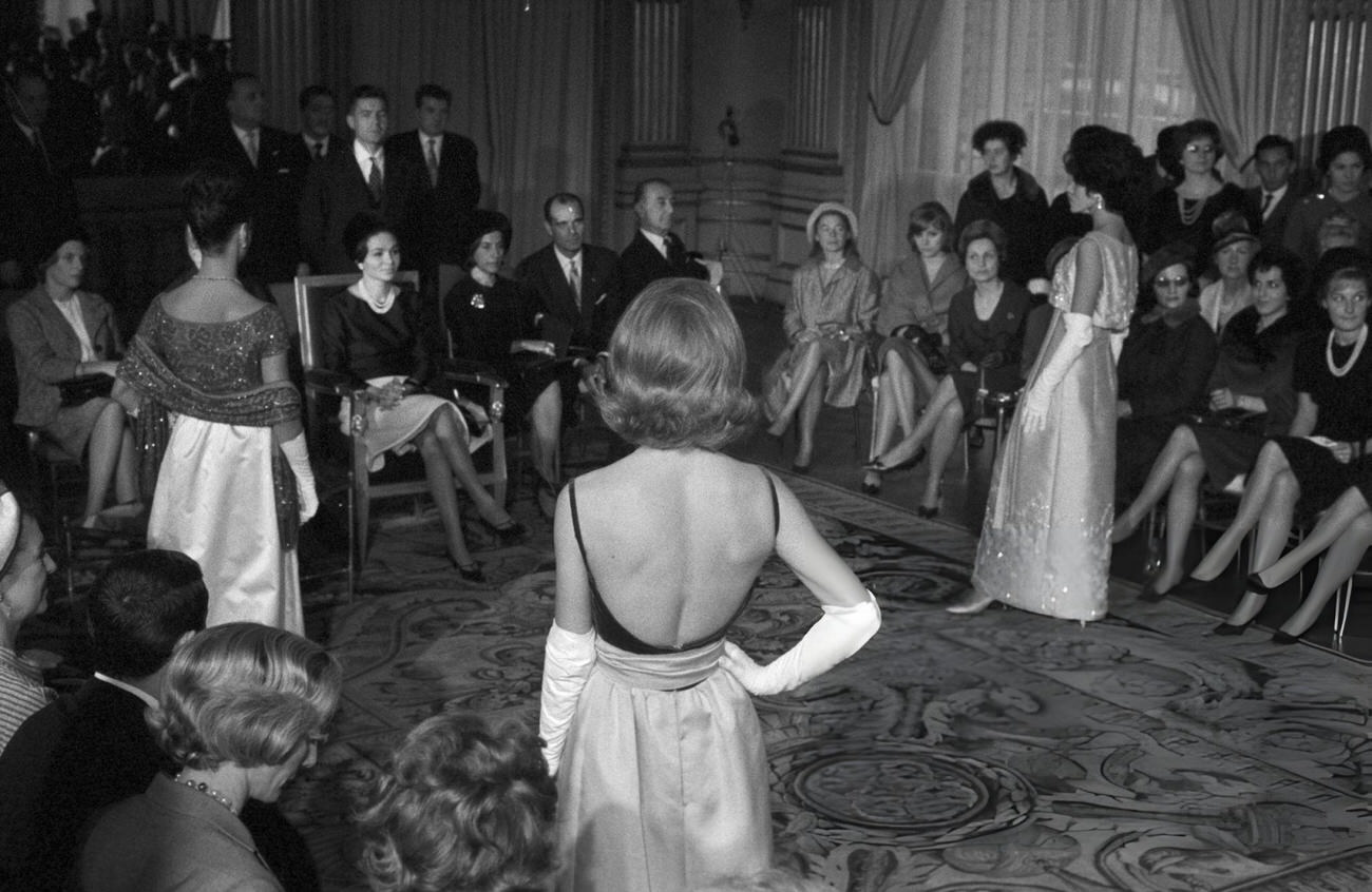 Farah Diba, Empress of Iran, attends a fashion show organized in her honor during the official visit of Shah Mohammad Reza Pahlavi to France, 1961.