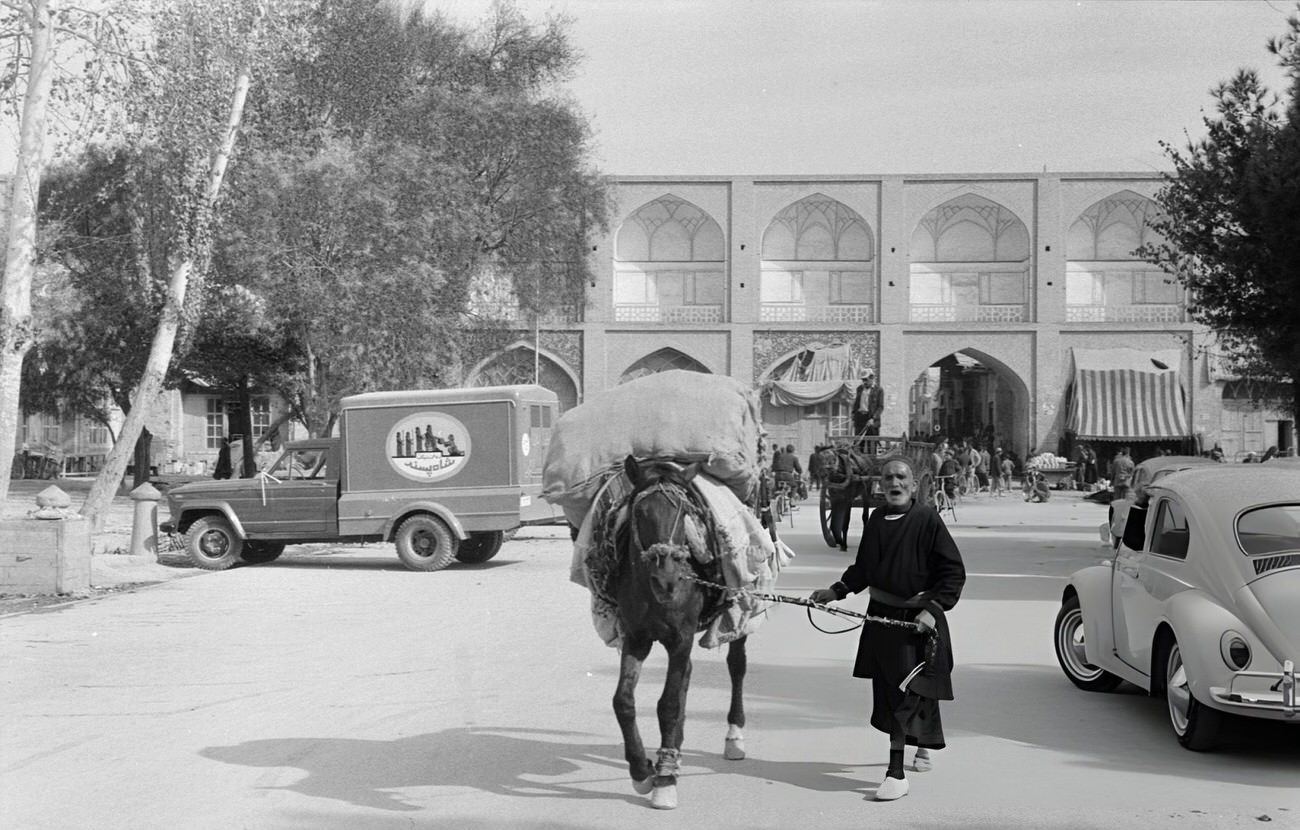 A man leading his horse loaded with goods, Isfahan, Iran, 1964.