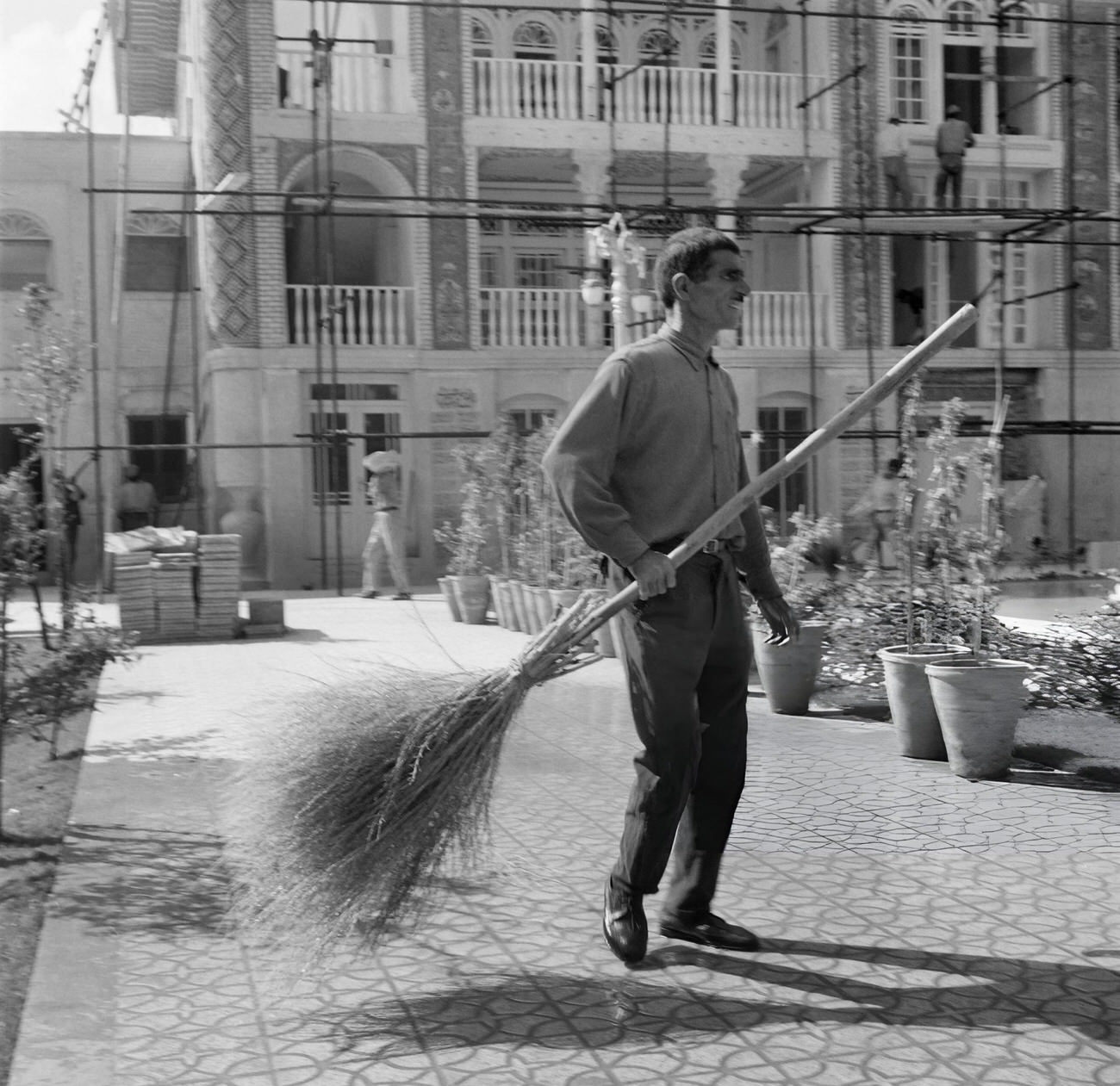 An Iranian man sweeping a street in a city of Iran, 1968.