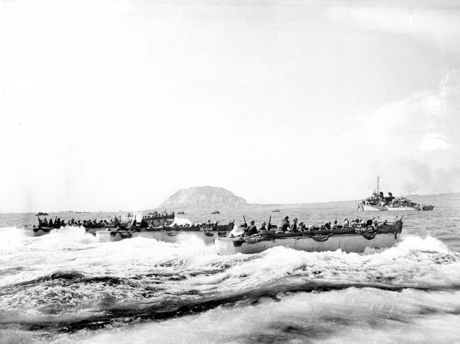 U.S. Marines aboard a landing craft head for the beaches of Iwo Jima Island, Japan, during World War II, 1945.