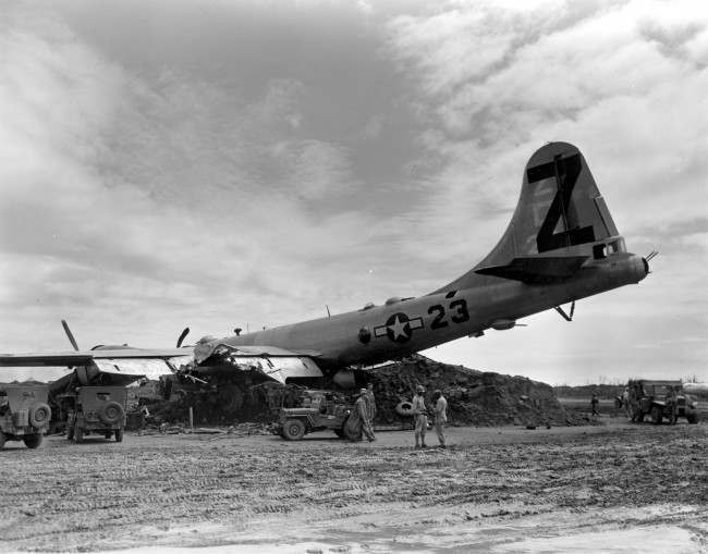 A B-29 Superfortress rests on a dirt mound after it crash landed with two engines working at Iwo Jima, Japan, during World War II, 1945.