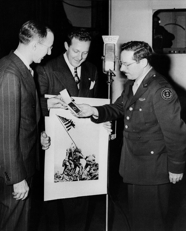 Joe Rosenthal, Associated Press photographer whose shot of the flag raising on Iwo Jima has become a classic, received further recognition when he was awarded the Graflex Diamond Award during an appearance on the “We, The People” television broadcast, 1945.